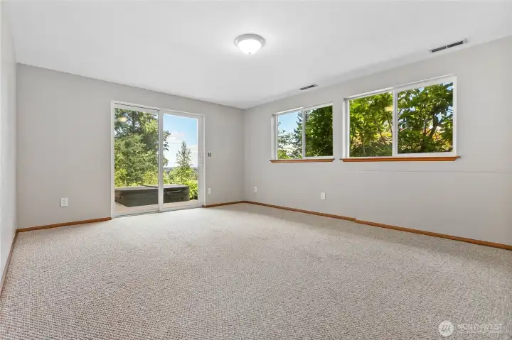 Lower level family room with deck access to hot tub. Lower level family room with deck access to hot tub.