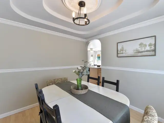 Formal dining room opens to the kitchen.