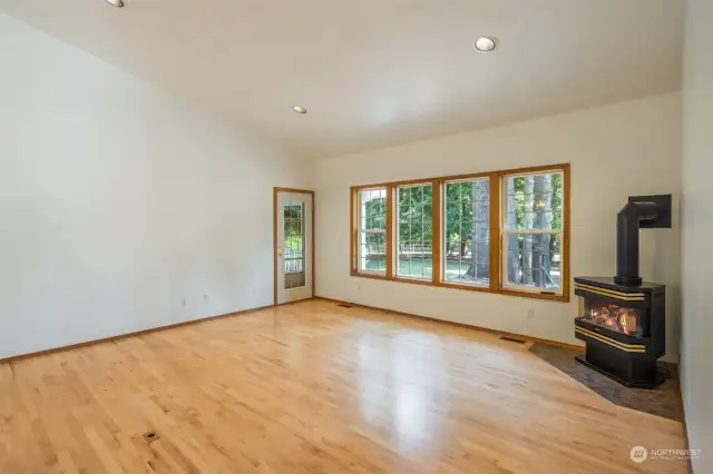 Living room with vaulted ceilings and propane freestanding stove