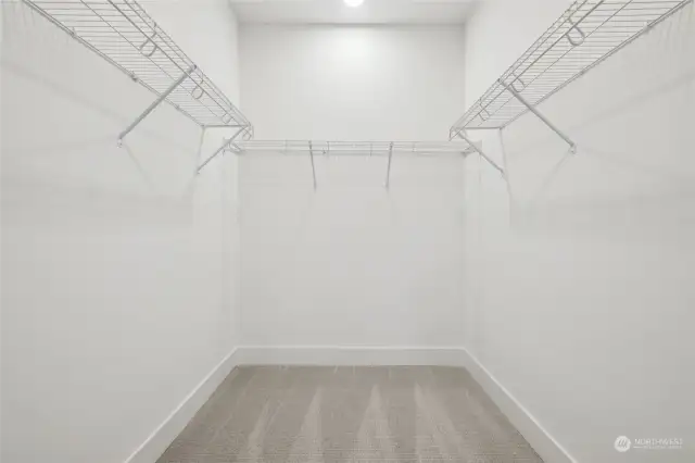 Spacious primary closet. Features and finishes may vary. For marketing use only