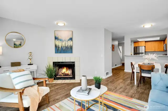Living room featuring upgraded flooring and lighting.  Cozy evenings by the wood burning fireplace.
