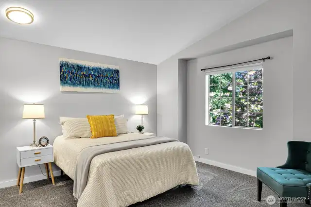 Primary Bedroom located upstairs with vaulted ceilings.