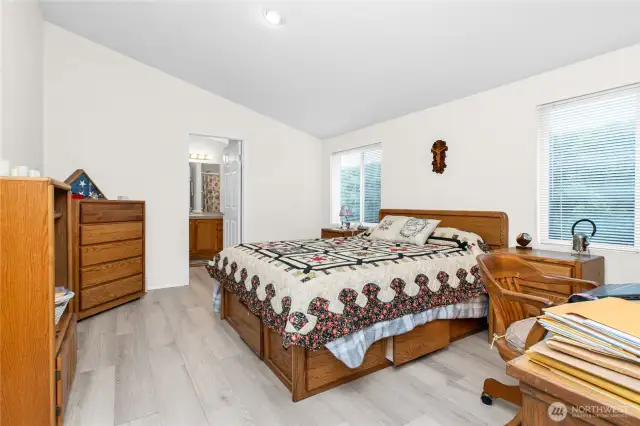 "The primary bedroom is spacious and features easy-care laminate flooring. With no curtains and a simple, clean design, it’s a great choice for those seeking a more hypoallergenic space."