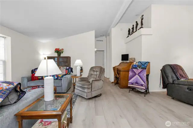 The spacious living room offers plenty of room to relax, gather, and make the space your own—whatever your needs may be.