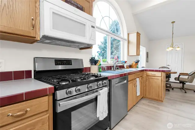 The spacious kitchen has lots of counter space and cupboards accented by stainless steel appliances.