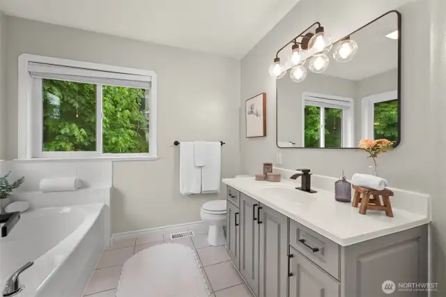 New fixtures and vanity highlight the primary ensuite, which includes a stand alone soaking tub and shower.