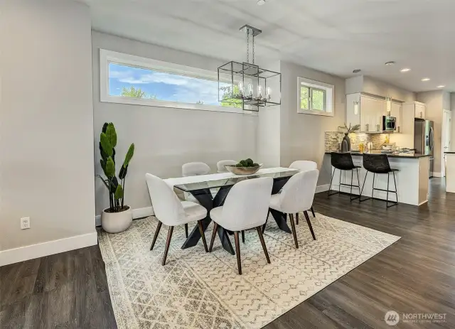 Gorgeous dining room, transom windows and designer light fixture, will be a joy for many gatherings.