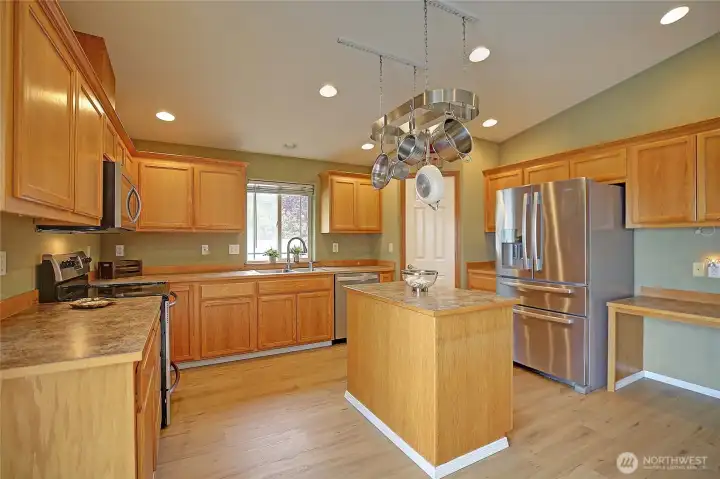 Large chef's kitchen with island offers ample cabinets & storage!