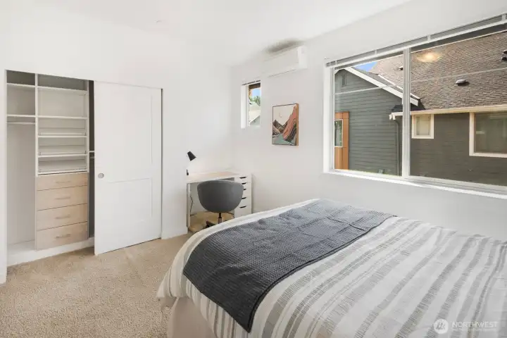 Every closet has been upgraded with California Closets' premium storage solutions. Second bedroom features a desk nook.