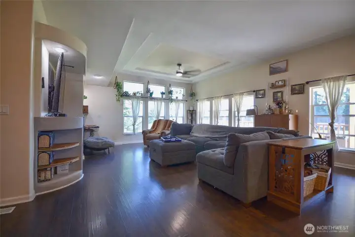 Another view of the spacious living room filled with comfort and charm.