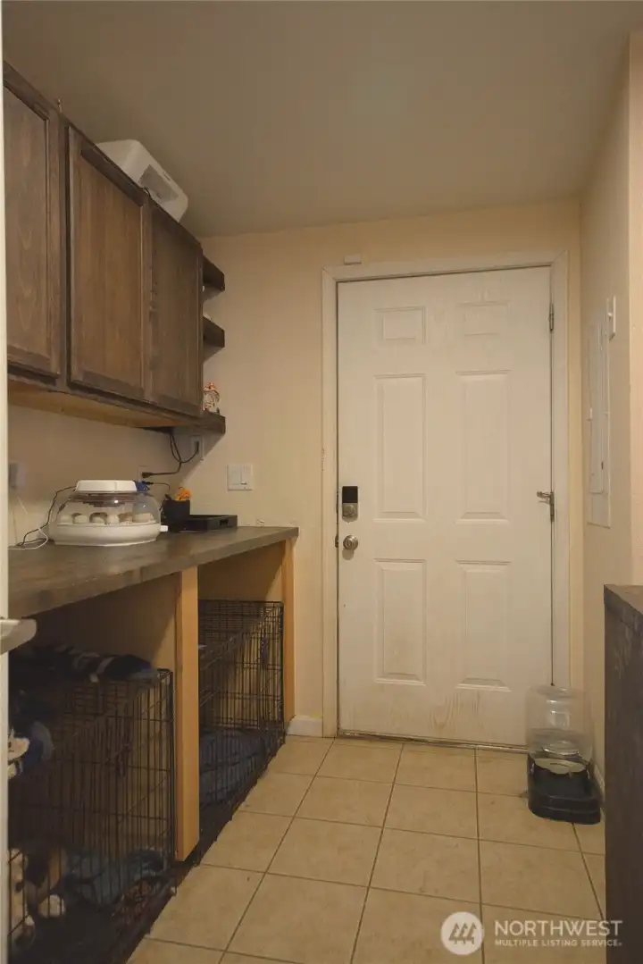 Laundry room with plenty of cabinets for storage and organized functionality.