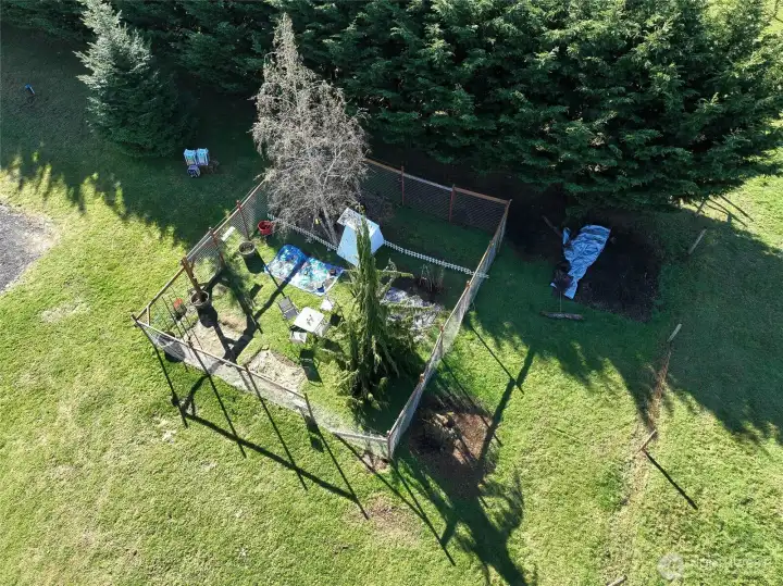 Secure fenced area by the garage to keep animals safe and contained.