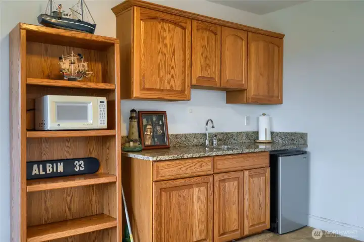 Lower level features a sink and a space for mini fridge or wine cooler.
