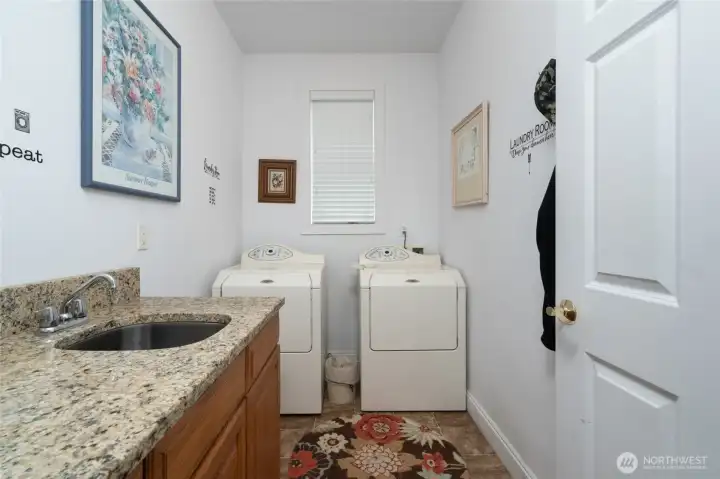The laundry room is located on the main floor and features a sink and ample counter space