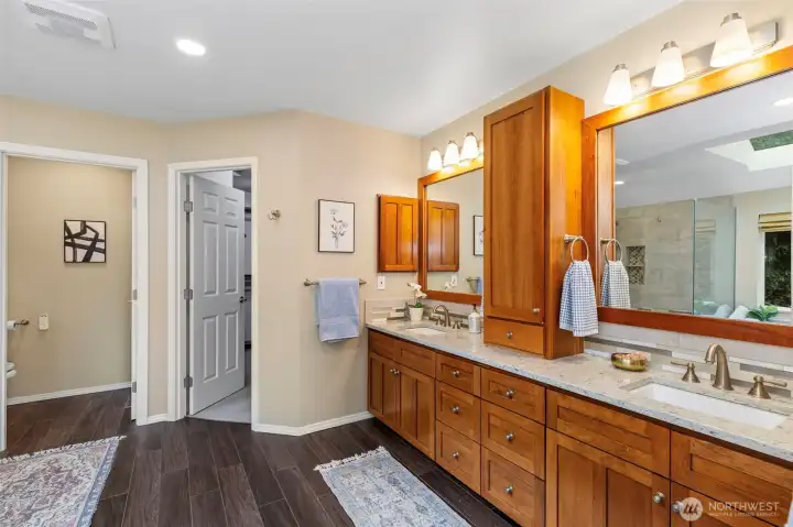 Custom updated 5-piece en-suite primary bathroom w/heated tile floors & custom-built walk-in closet