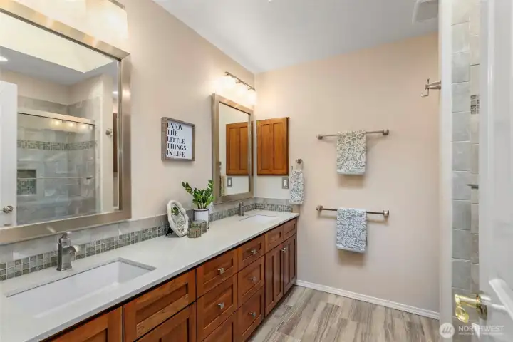 Guest bathroom with updated vanities & heated tile floors.