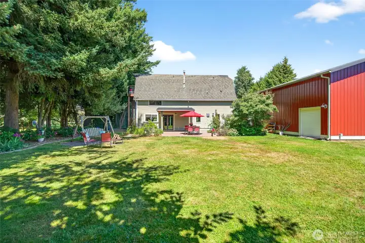 Large patio area with lawn area for a campfire space. Side roll up door for entry into the shop. Large patio area with lawn area for a campfire space. Side roll up door for entry into the shop.