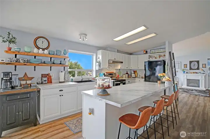 Open-concept kitchen with large island seating, seamlessly flowing into the living area.