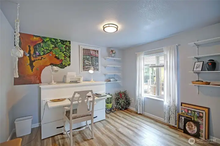 Bedroom located just off the entry and utility room, offering flexible space for guests, an office, or additional living.
