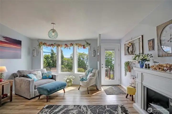 Bright living space with expansive windows, water views, and easy access to the outdoor deck.