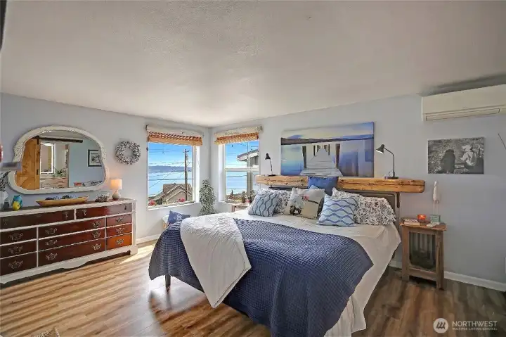 Light-filled primary suite featuring water views, mini-split climate control, and a generous walk-in closet.