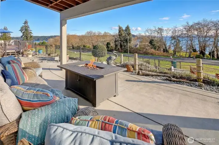 Covered outdoor entertainment area with peaceful landscaping and waterviews.