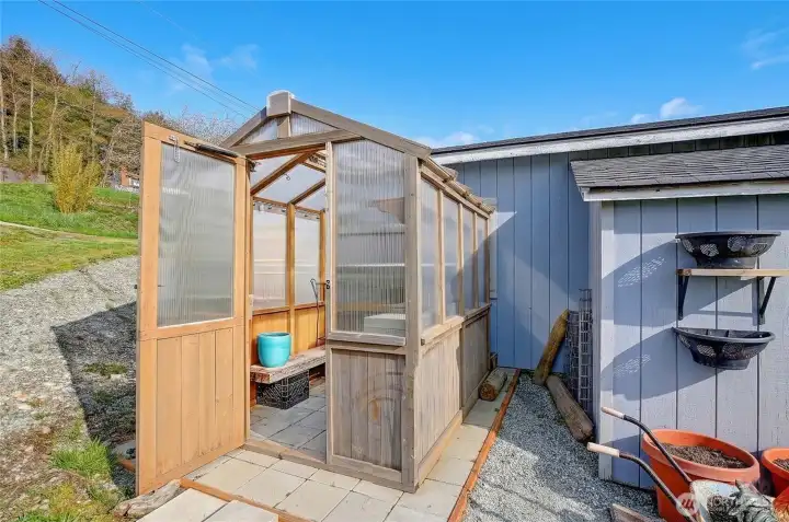 Charming greenhouse, perfect for year-round gardening, planting, and outdoor hobbies.