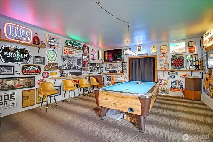 Incredible entertainment room built into the garage/shop, creating the ultimate space for hosting, games, and unforgettable gatherings.
