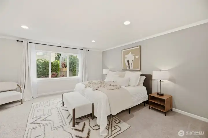 Oversized Primary Bed with mature landscape and retaining wall for privacy in back.