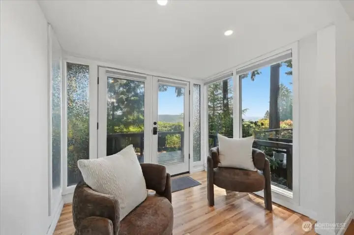 Primary sitting room with French doors connecting to the deck. Primary sitting room with French doors connecting to the deck.