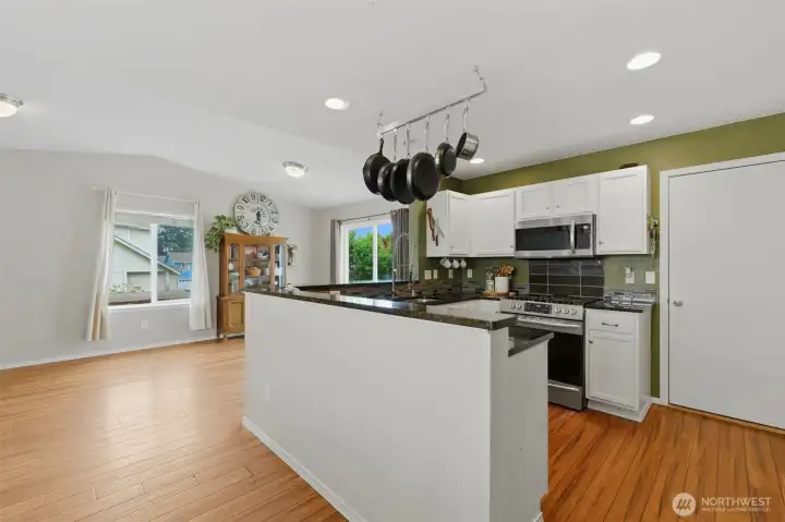 Just beyond the kitchen and dining space is a large room/place space/office that leads onto the deck and into the backyard.