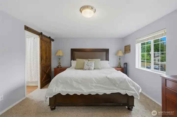 Primary bedroom has two closets and an en suite bath with dual vanities