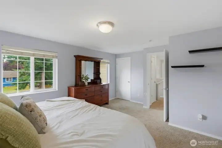 Primary bedroom has two closets and an en suite bath with dual vanities