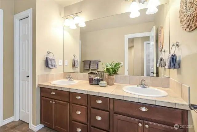 Hall bath with dual vanities and private tub/shower not shown.