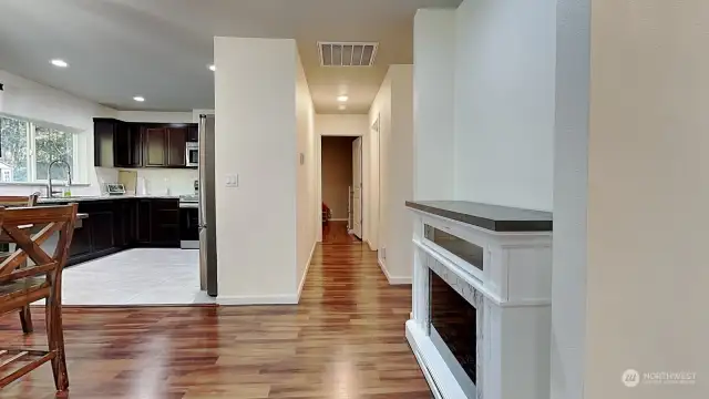 First look into the bright, great room effect, looking down the hallway, and kitchen