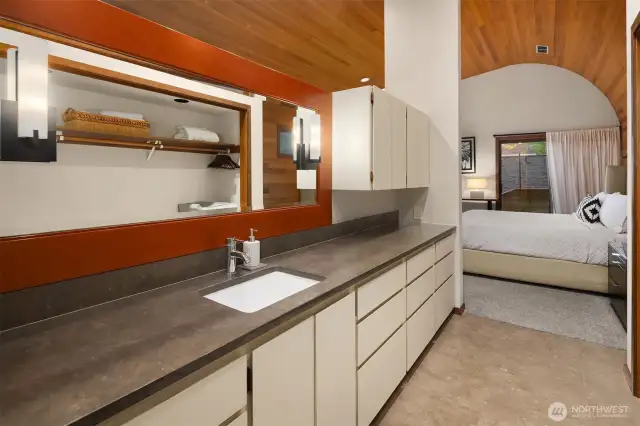 The primary bathroom enjoys ample counter space, shower, stackable washer dryer and plenty of storage.