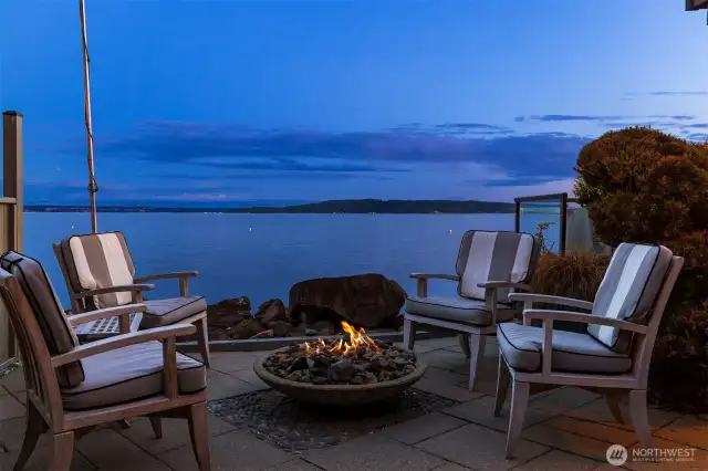 Firepit and conversations. The land along the shoreline has been designed to maximize the space and to create privacy from the street and other waterfront owners. While on site, notice on the west side the built-in screen that can be closed or left open to access the beach.