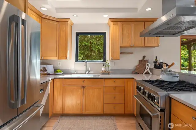 Stainless appliances play nicely off the natural wood cabinets with full-height uppers.