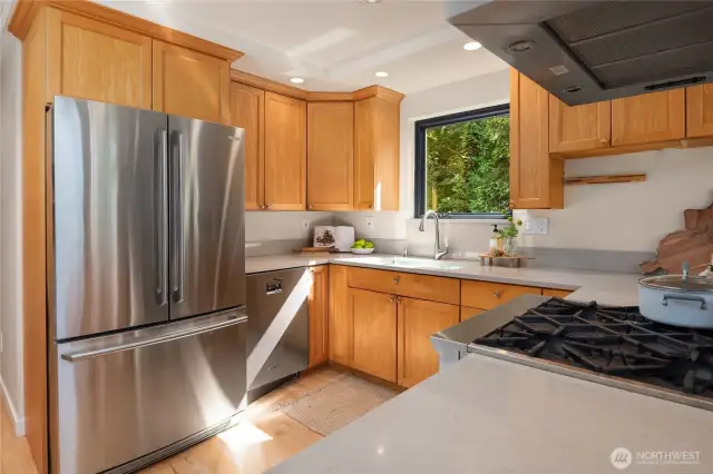 Undermount sink, beautiful wood cabinetry and even a high bar to the right.