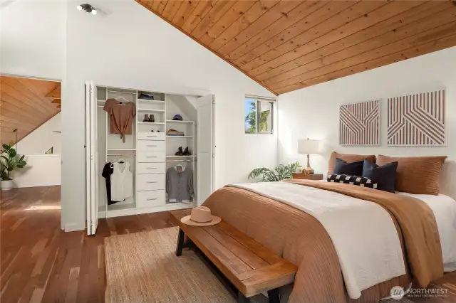 A spacious wardrobe closet with built-in organizers is a part of this fabulous primary.