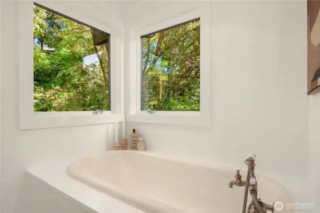 This soaking tub features 2 windows with nothing but nature looking in.