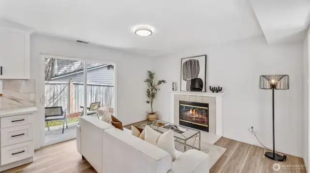 Sunlit living area with a cozy wood-burning fireplace—perfect for relaxing or entertaining.