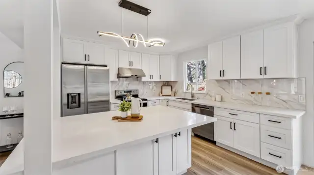 . The spacious kitchen offers new cabinetry and quartz countertops.