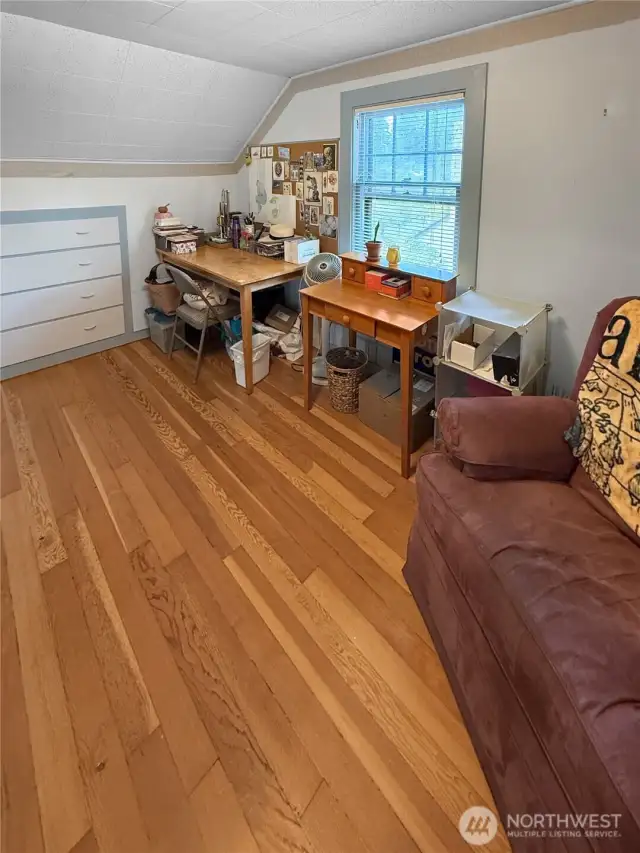 At the top of the stairs, discover a tucked-away nook that’s perfect for crafting, writing, or working from home. Built-in drawers, natural light, and vintage trim make this space as functional as it is charming. Whether you’re an artist, organizer, or dreamer, this flexible zone is ready to inspire.
