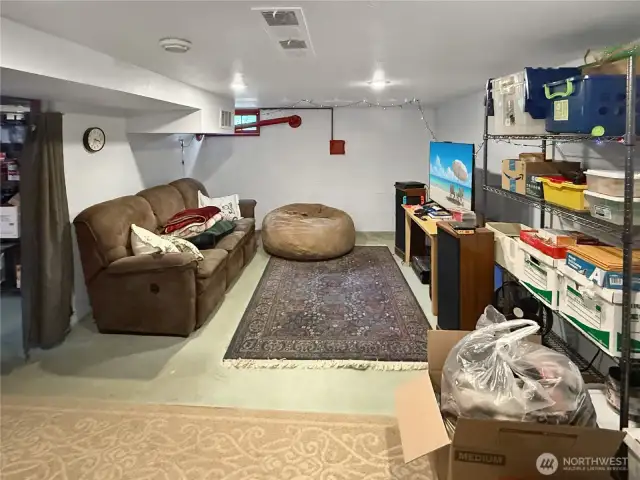 Stretch out and get comfortable in this lower-level rec room — perfect for movie nights, game marathons, or creating your own personal retreat. With plenty of room for lounging and built-in shelving for storage, this versatile space is a functional bonus that adapts to your lifestyle. Whether you’re hosting friends or just escaping for some downtime, this spot delivers.