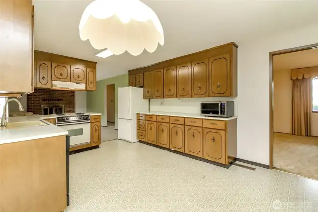 Kitchen opens to large family room and doorway to formal dining room.