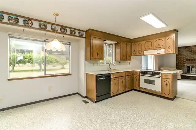 Big window floods breakfast nook with natural light.