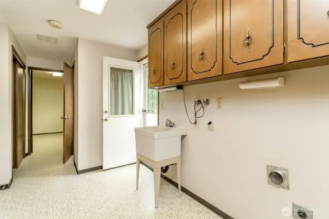 Huge utility room, door by office is a half bath!