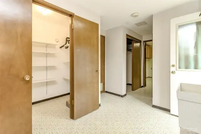Utility room with walk-in pantry, entrance to garage, entrance to backyard and half bath and office.