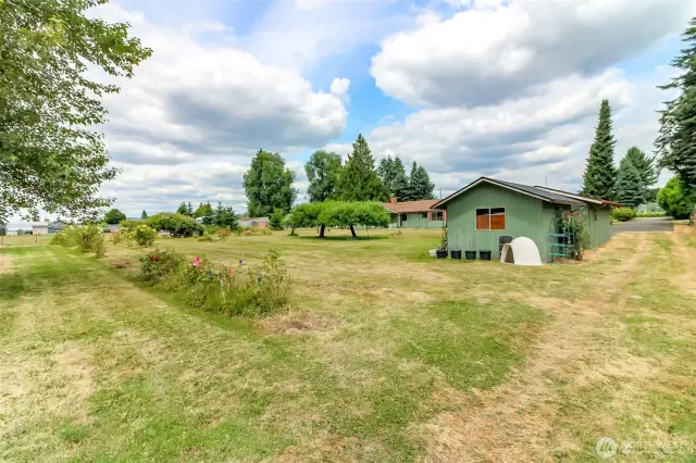 Notice road to back to the back pasture on the far side of the property next to two car tandem garage and garden shed.